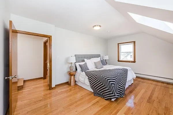 a bedroom with a bed and a window
