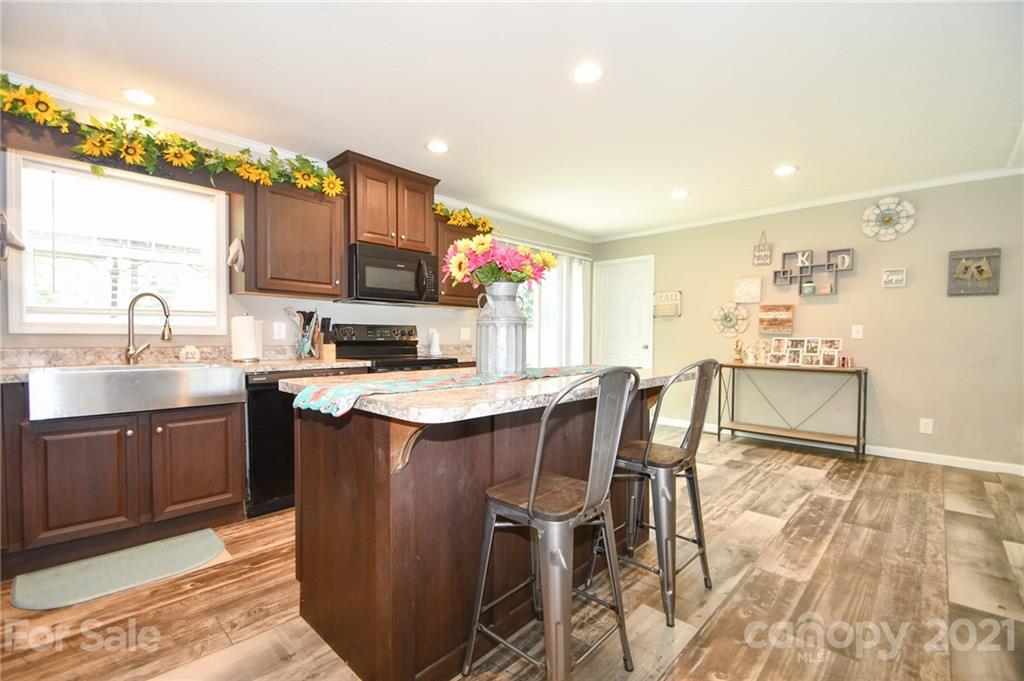 2503 Hargette Road Monroe, NC 28112 - Photo 5 of 11 a kitchen with stainless steel appliances granite countertop a sink stove and cabinets