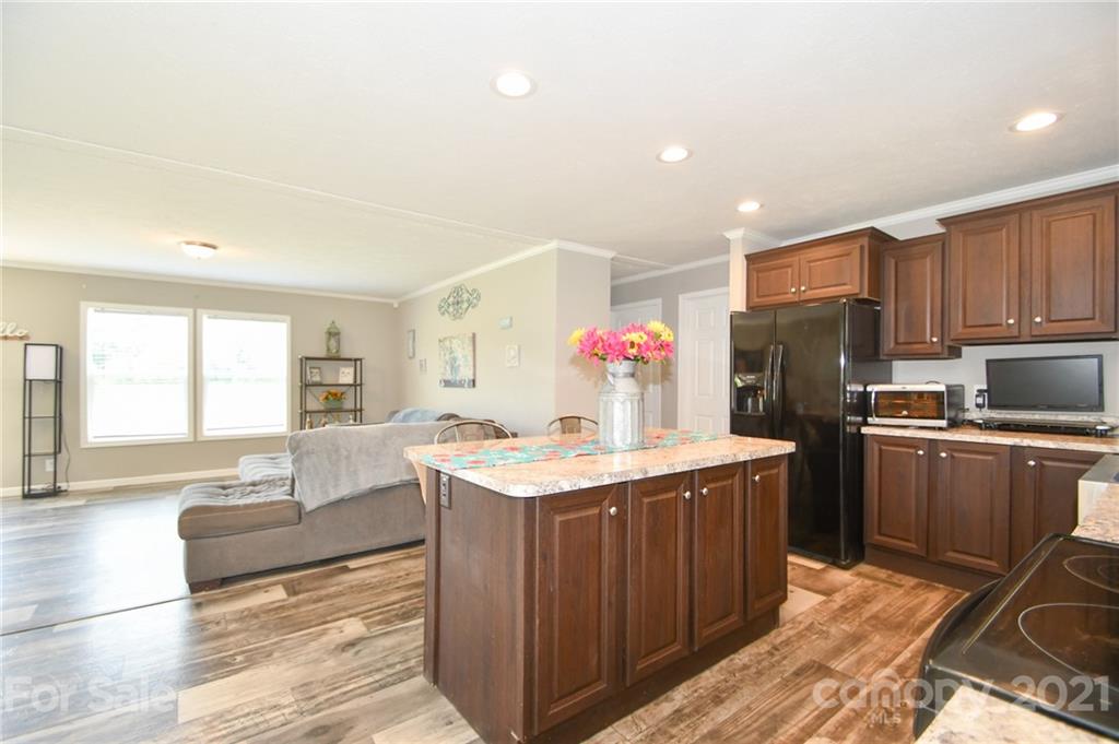 2503 Hargette Road Monroe, NC 28112 - Photo 7 of 11 a kitchen with kitchen island granite countertop a sink stove and refrigerator