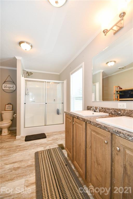 2503 Hargette Road Monroe, NC 28112 - Photo 10 of 11 a bathroom with a sink a mirror and a shower