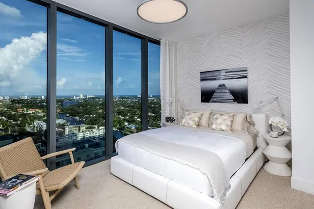 a bedroom with a bed and large window