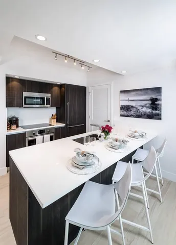 a kitchen with a dining table and chairs