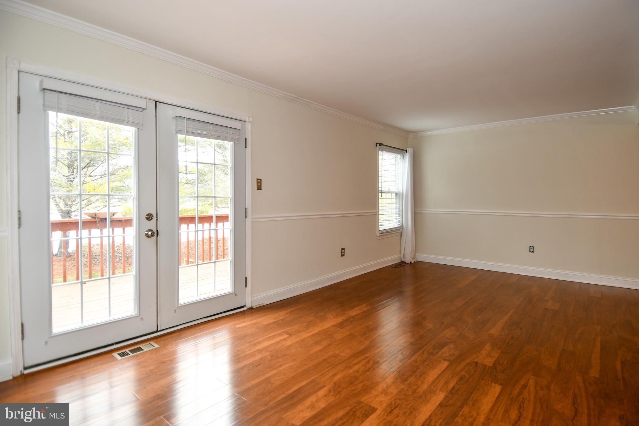 11796 Lone Tree Court Columbia, MD 21044 - Photo 13 of 45 a view of an empty room with wooden floor and a window