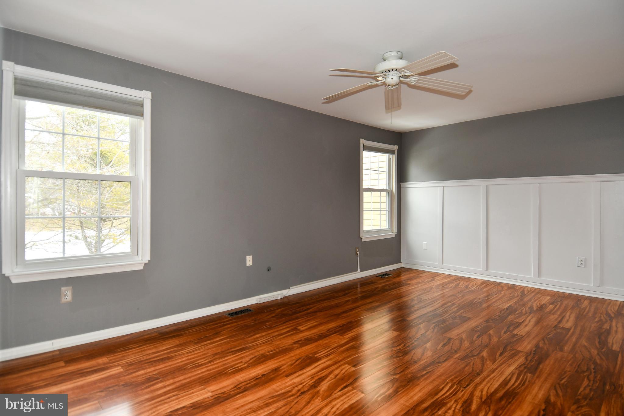 11796 Lone Tree Court Columbia, MD 21044 - Photo 16 of 45 a view of an empty room with wooden floor and a window