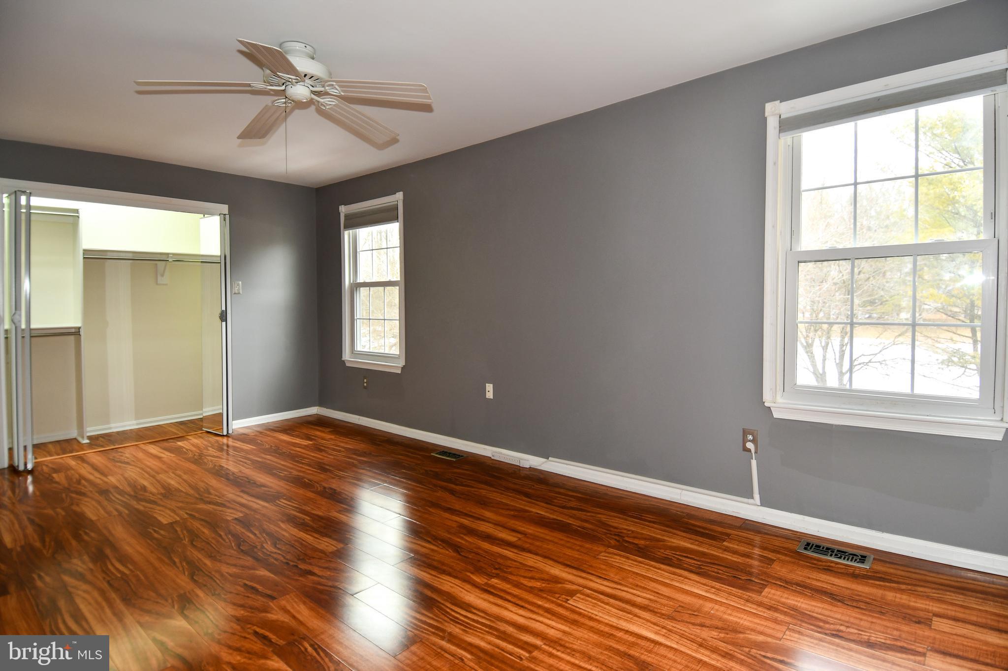 11796 Lone Tree Court Columbia, MD 21044 - Photo 17 of 45 a view of empty room with wooden floor and fan