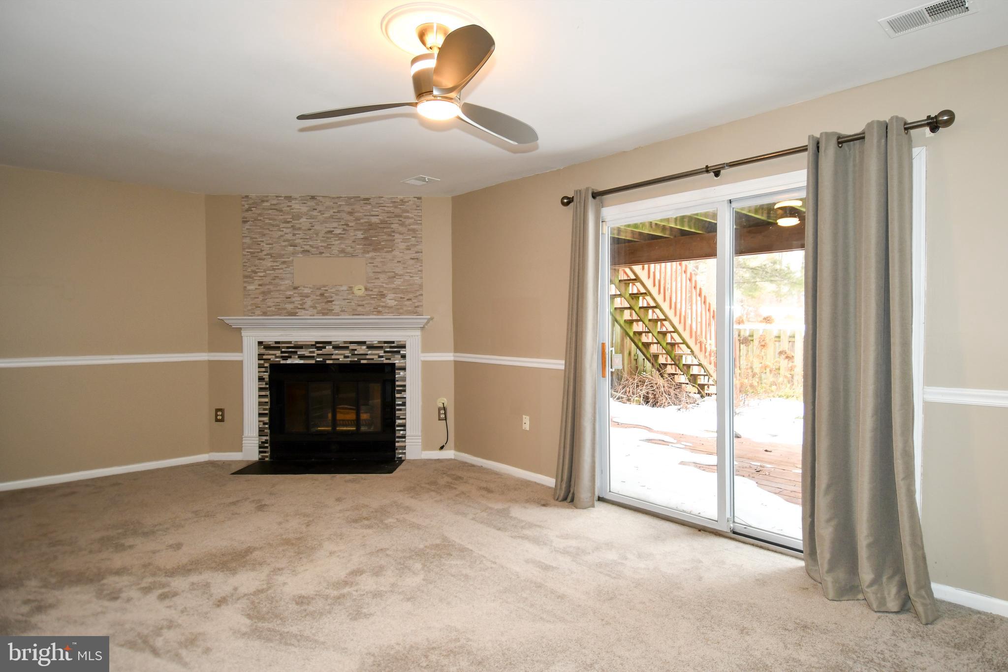 11796 Lone Tree Court Columbia, MD 21044 - Photo 28 of 45 a view of an empty room with a fireplace and a window