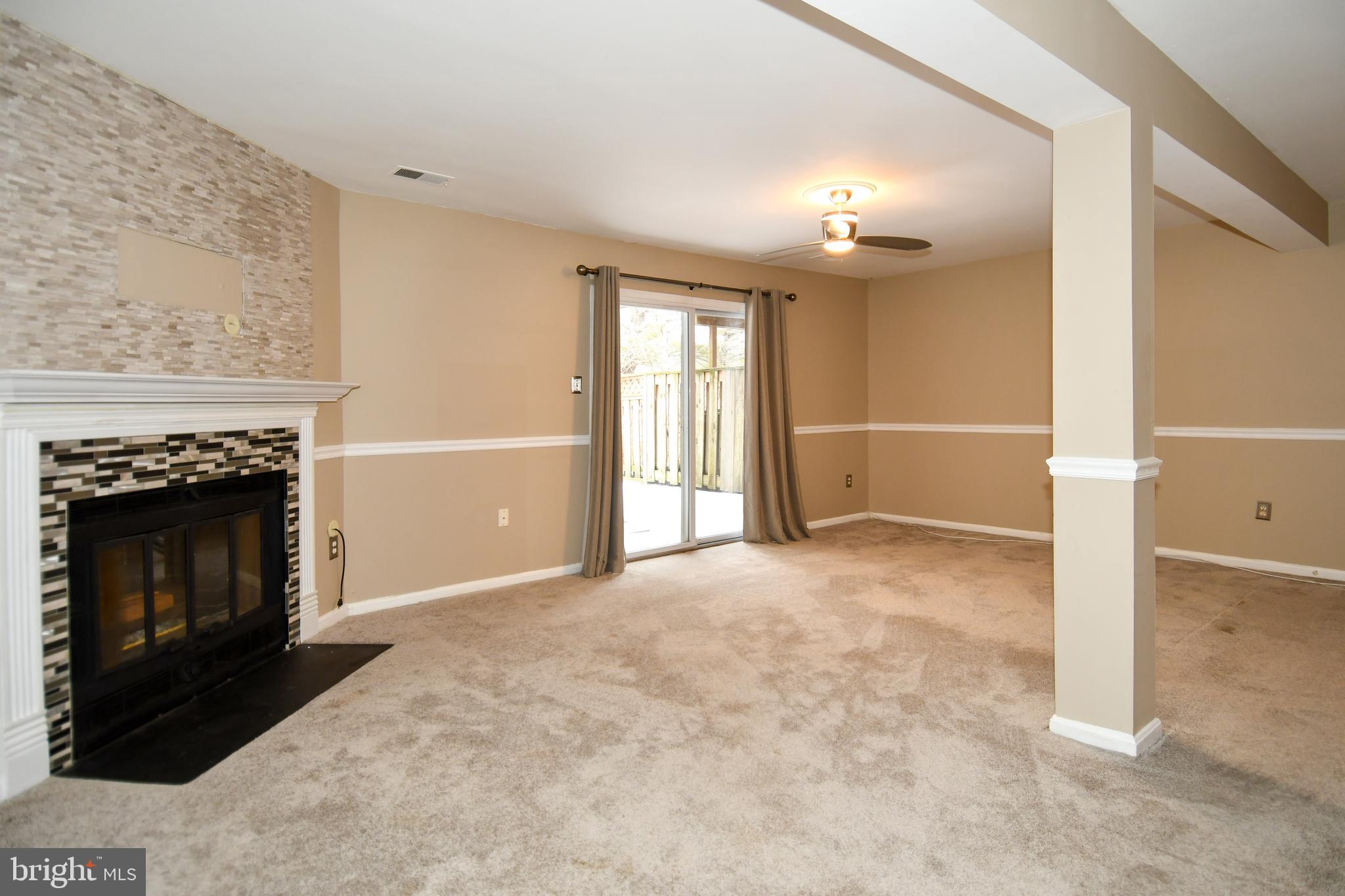 11796 Lone Tree Court Columbia, MD 21044 - Photo 29 of 45 an empty room with windows and fireplace