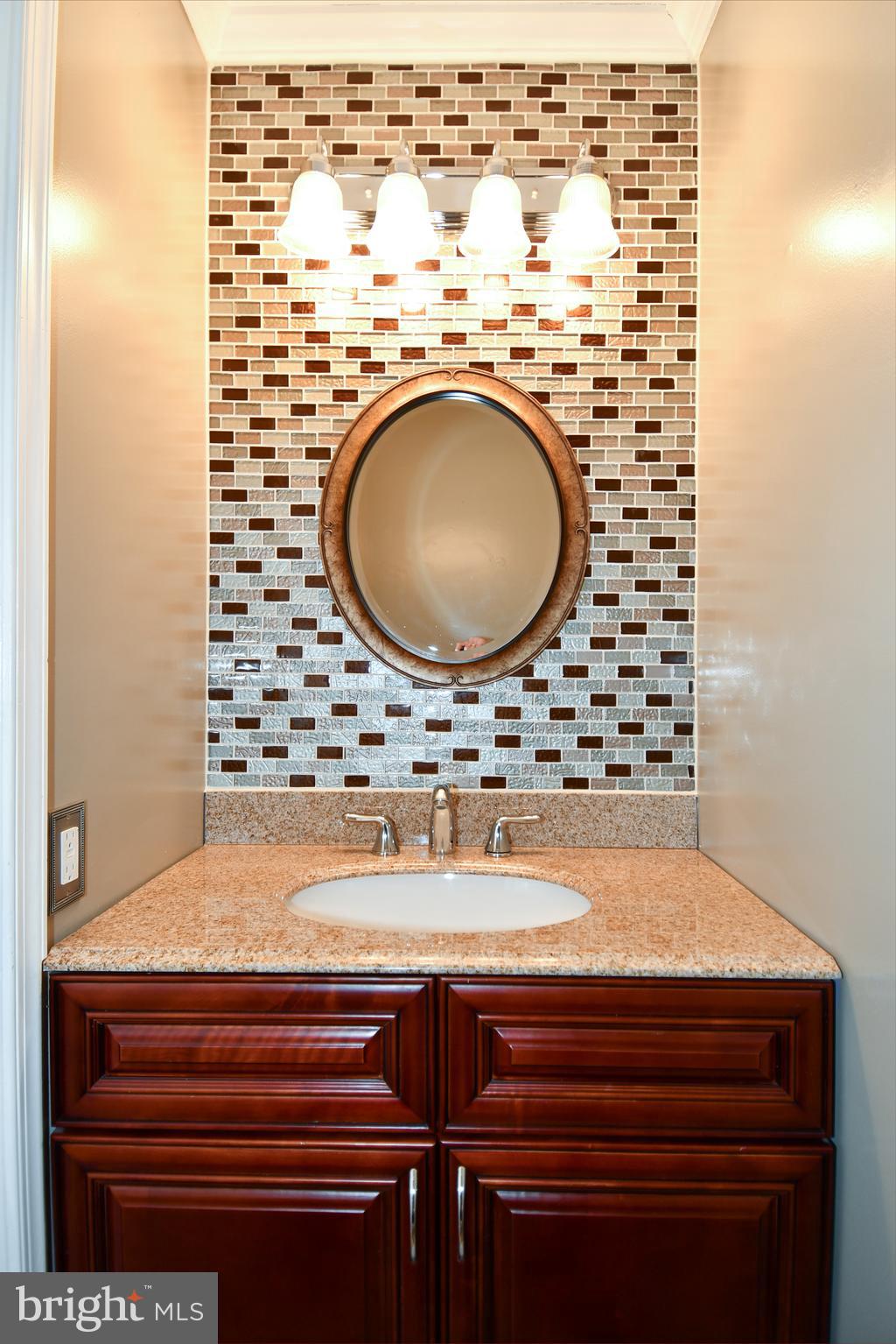 11796 Lone Tree Court Columbia, MD 21044 - Photo 6 of 45 a bathroom with a granite countertop sink and a mirror