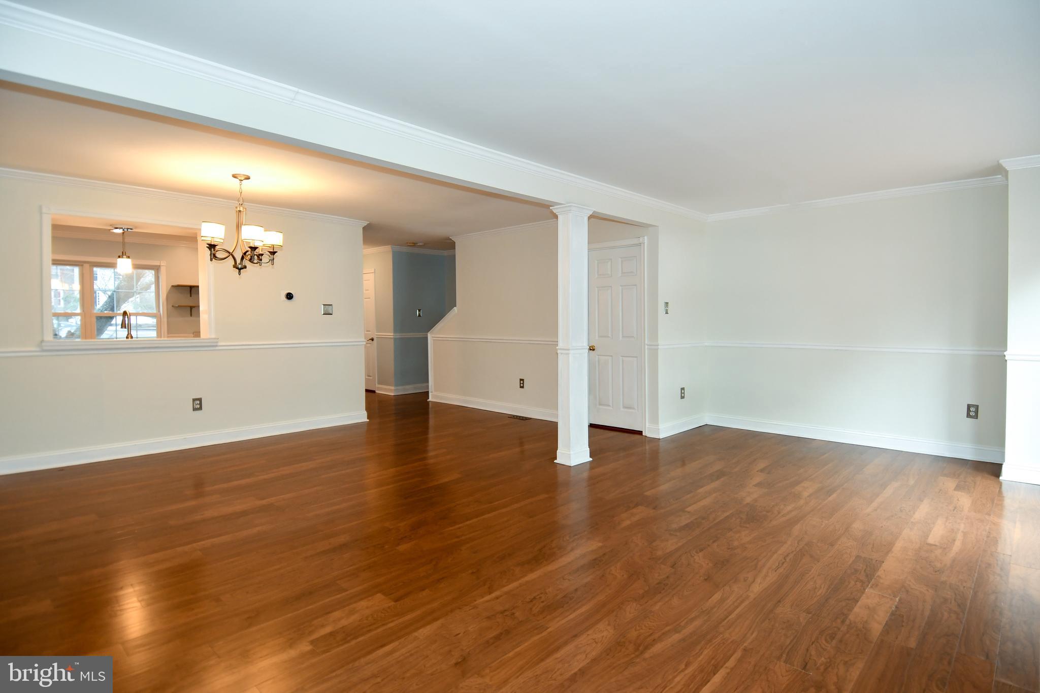 11796 Lone Tree Court Columbia, MD 21044 - Photo 10 of 45 an empty room with wooden floor and windows