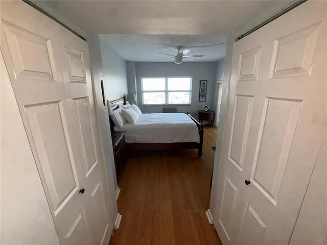 a view of a hallway with wooden floor and a large window