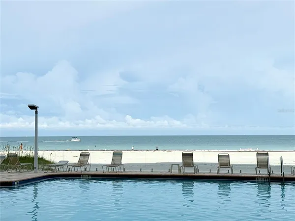 a view of swimming pool with chairs