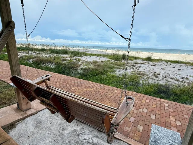 a room with lots of white furniture and window