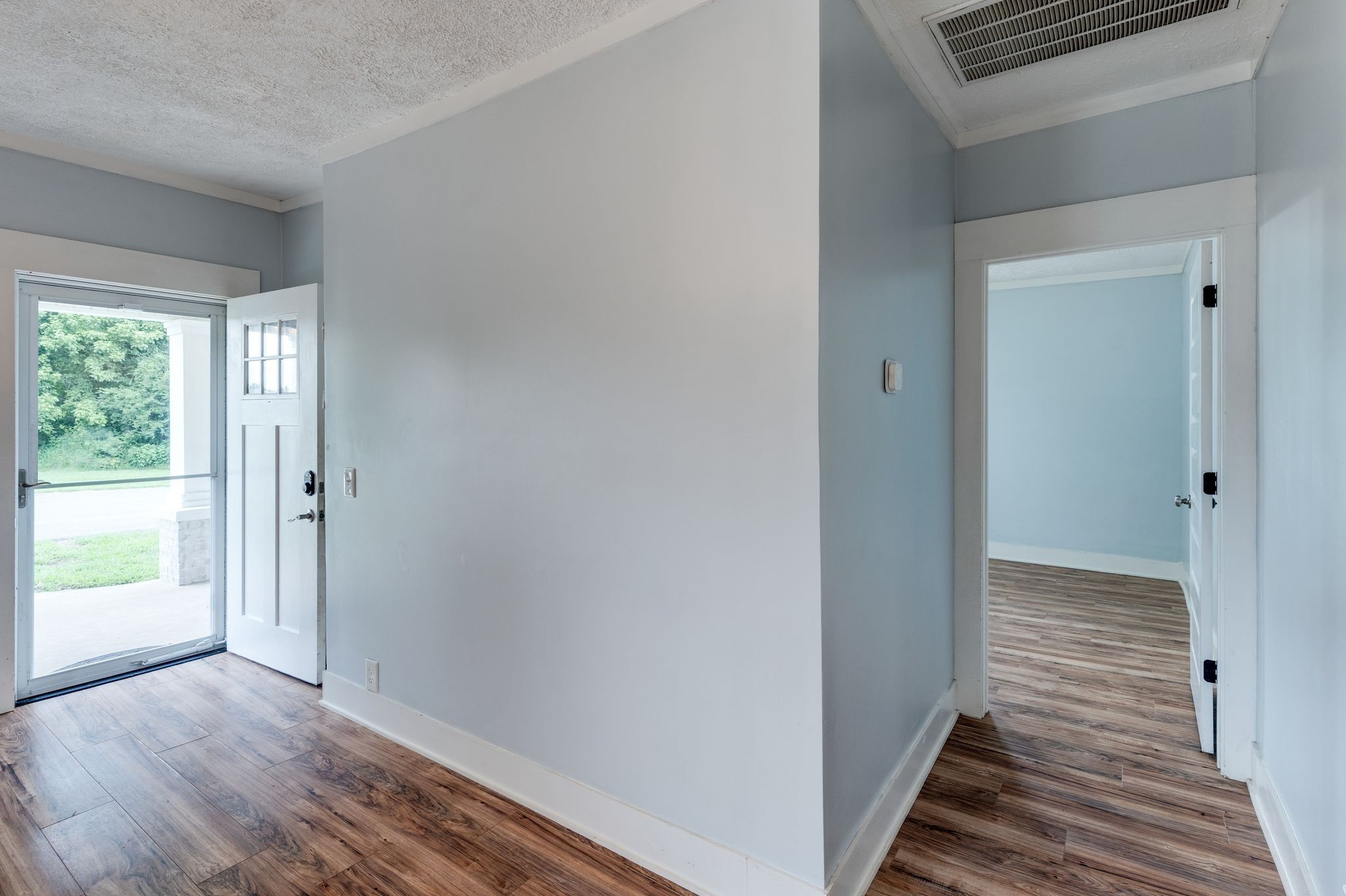 101 Fairfield Road Bethpage, TN 37022 - Photo 14 of 35 a view of a hallway with wooden floor and a bathroom