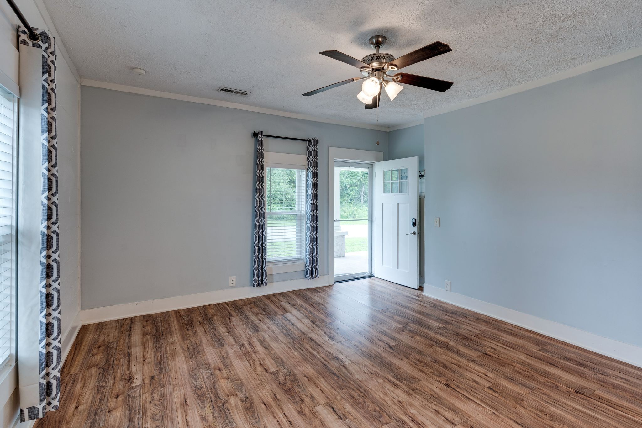 101 Fairfield Road Bethpage, TN 37022 - Photo 10 of 35 an empty room with wooden floor and windows
