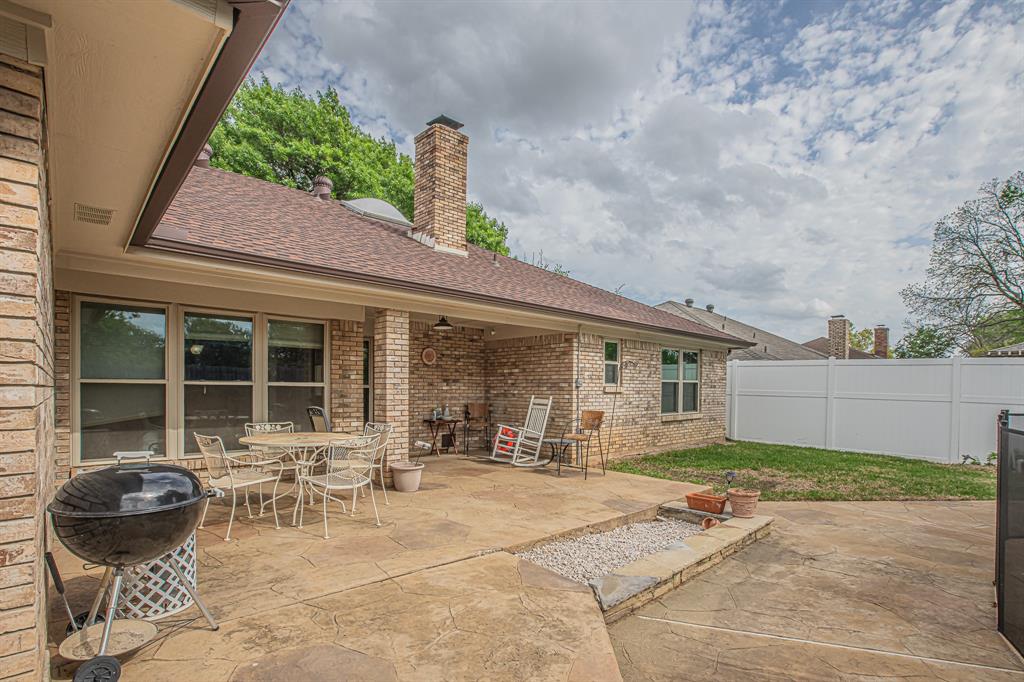 3309 Timber View Circle Bedford, TX 76021 - Photo 37 of 38 a backyard of a house with table and chairs