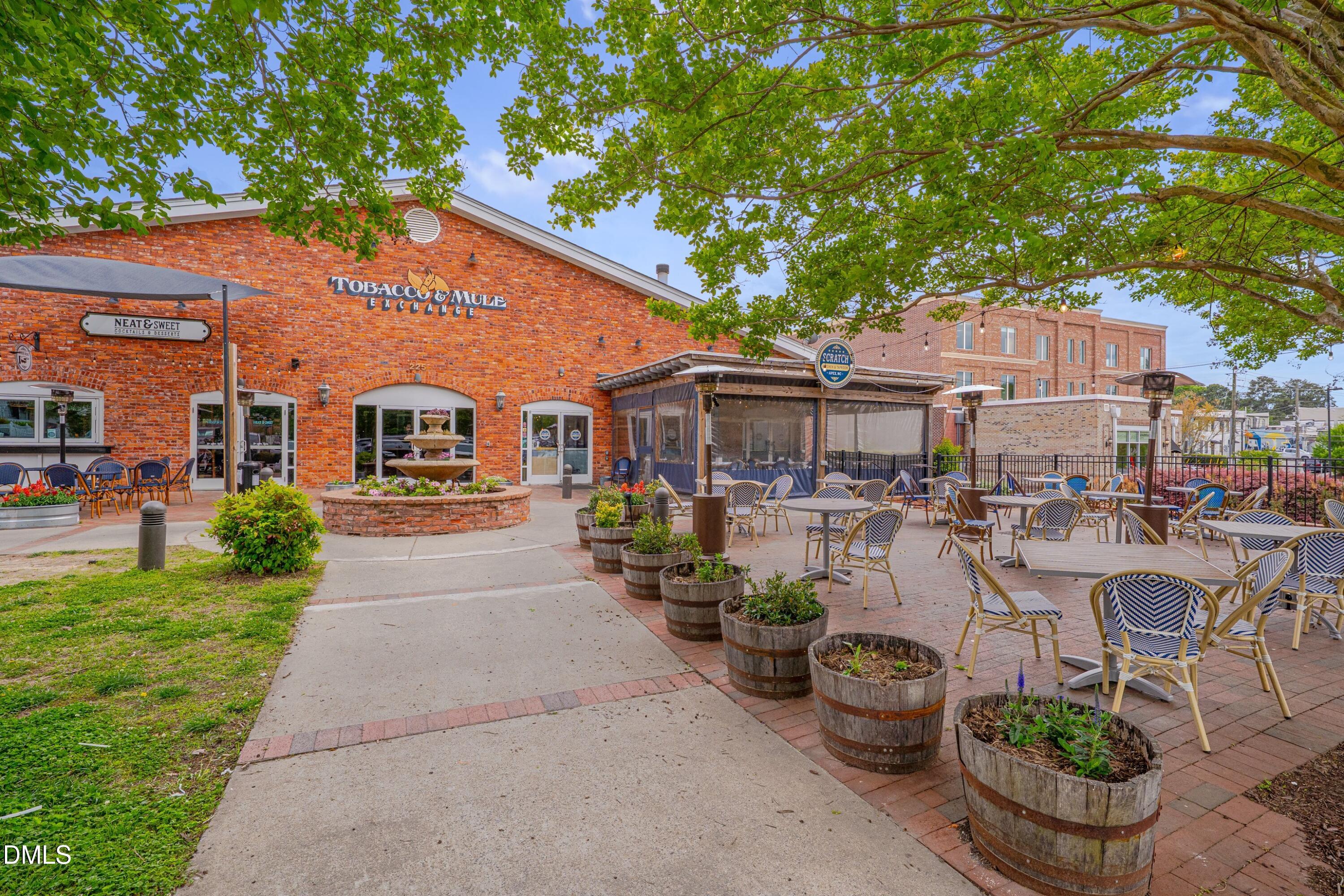 309 Culvert Street Apex, NC 27502 - Photo 8 of 15 a view of a patio with table and chairs potted plants and a large tree
