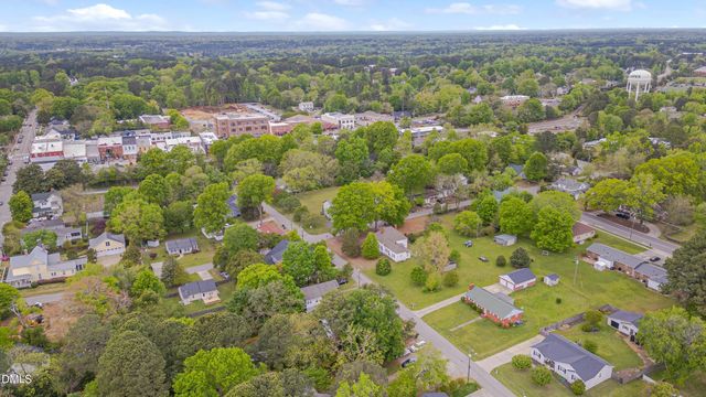 an aerial view of a residential houses with outdoor space