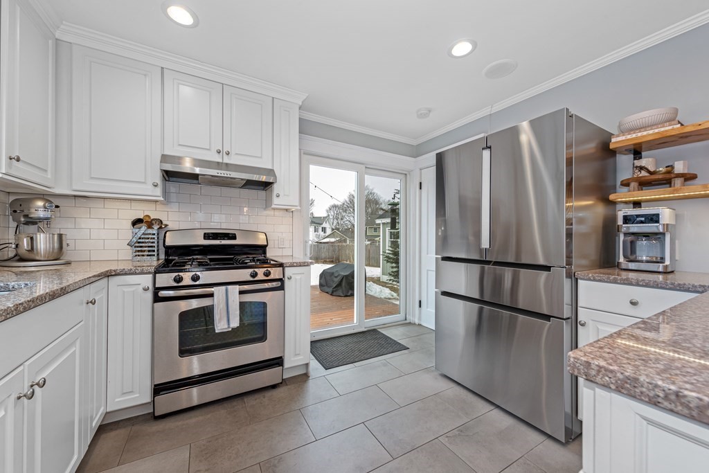 6 Storey Avenue Newburyport, MA 01950 - Photo 13 of 41 a kitchen with stainless steel appliances granite countertop a refrigerator stove and cabinets