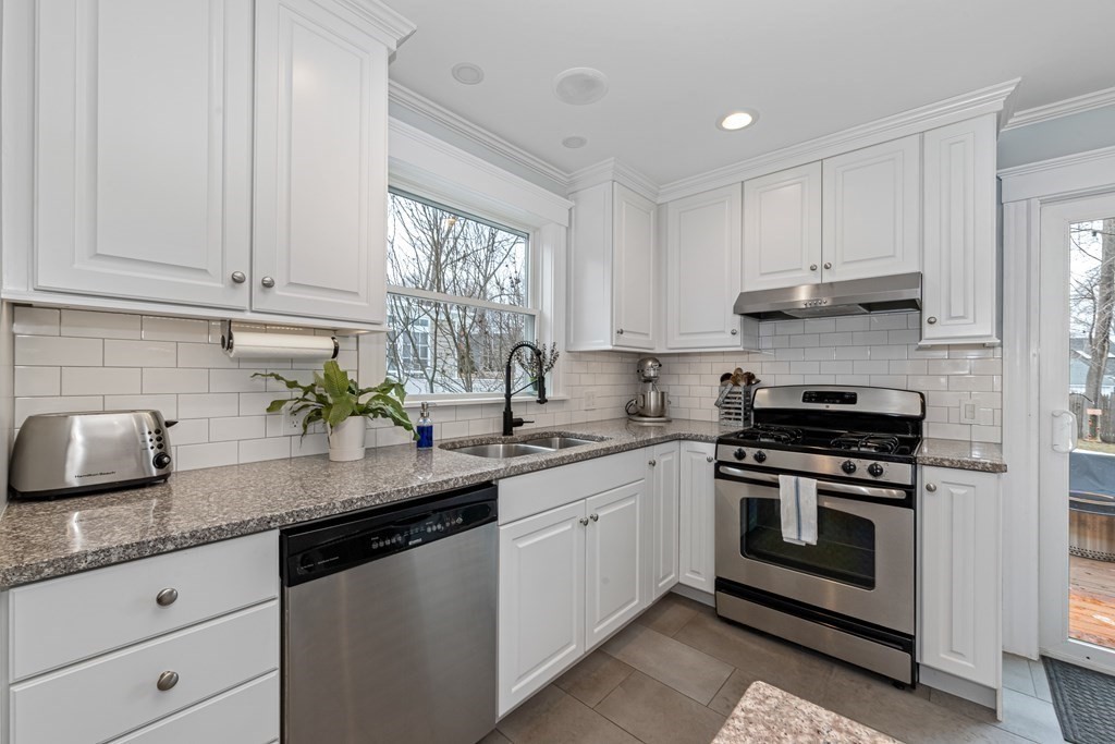 6 Storey Avenue Newburyport, MA 01950 - Photo 14 of 41 a kitchen with stainless steel appliances granite countertop a sink a stove and cabinets