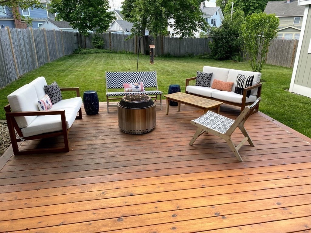 6 Storey Avenue Newburyport, MA 01950 - Photo 39 of 41 a view of a patio with dining table and chairs with wooden fence