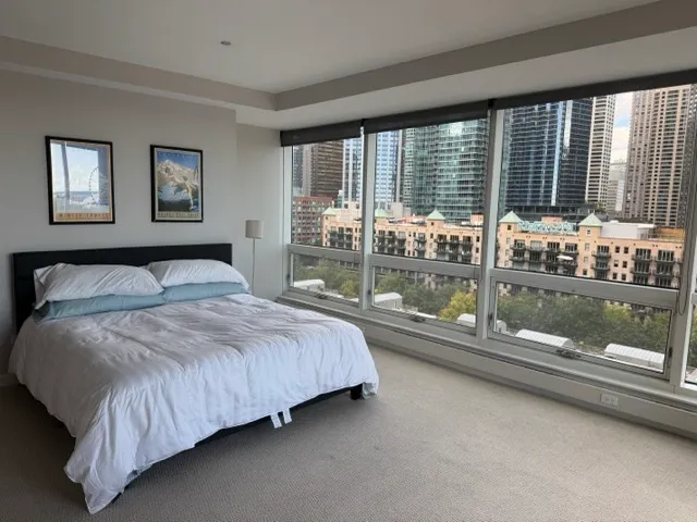 a bedroom with a large bed and a large window