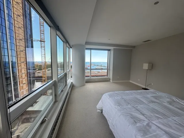 a bedroom with a large bed and a large window