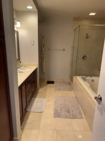 a bathroom with a tub sink and mirror