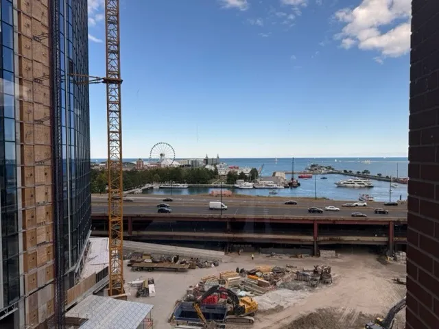 a view of balcony with two chairs and a potted plant
