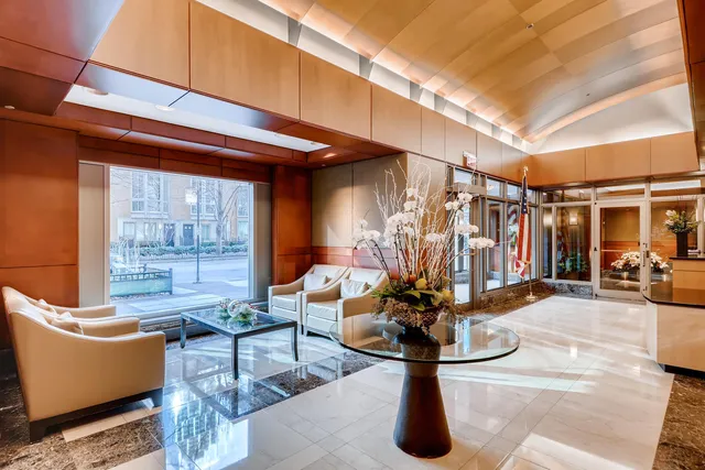 a living room with furniture a window and gym equipment