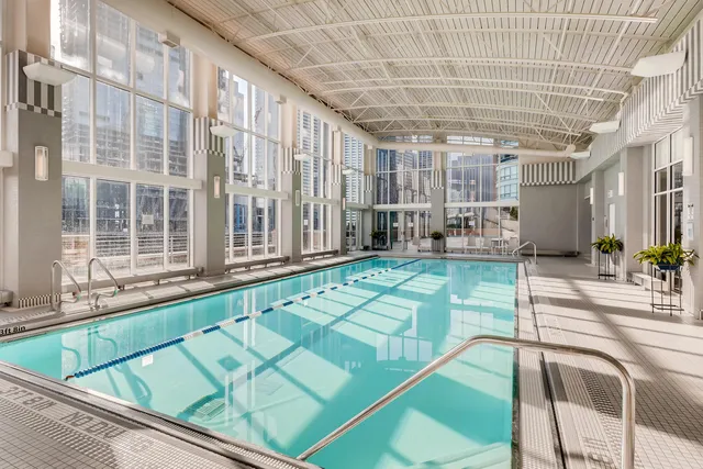 a swimming pool with outdoor seating and yard