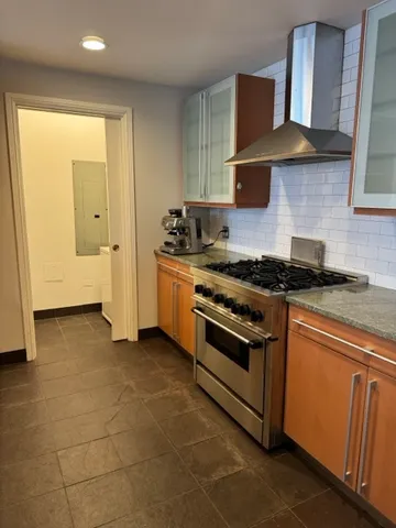 a kitchen with stainless steel appliances granite countertop a stove and a refrigerator