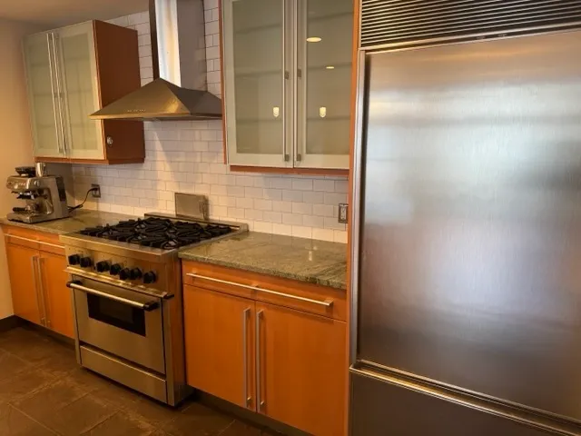 a kitchen with a stove and a refrigerator