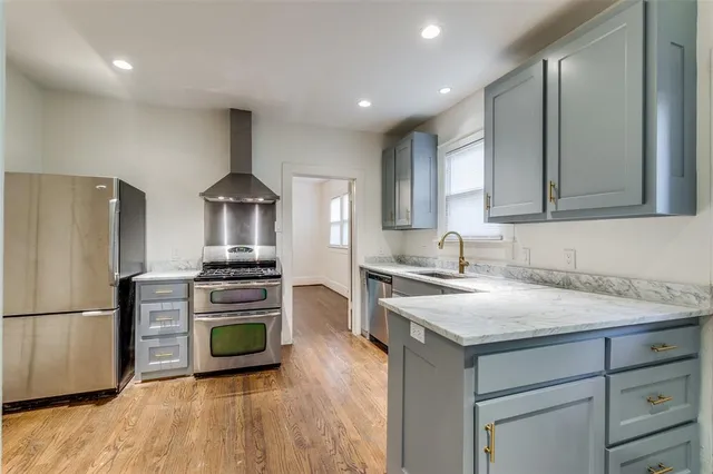a kitchen with a refrigerator and a stove top oven