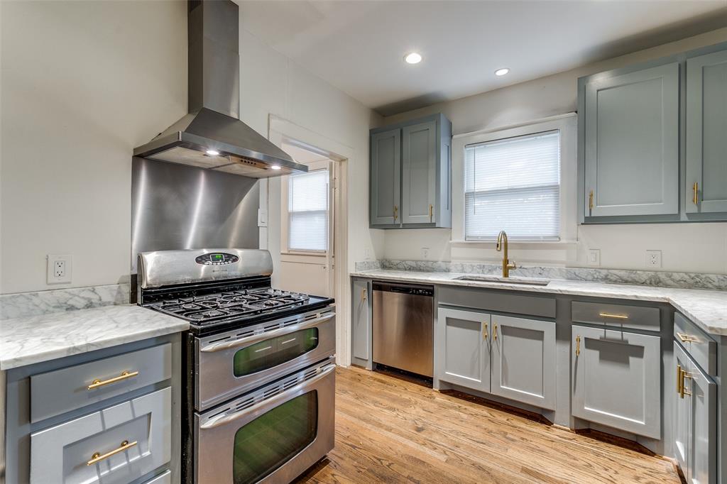 732 North Windomere Avenue Dallas, TX 75208 - Photo 12 of 33 a kitchen with granite countertop a sink cabinets and stainless steel appliances