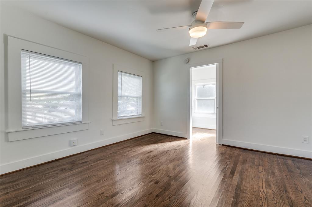 732 North Windomere Avenue Dallas, TX 75208 - Photo 21 of 33 an empty room with wooden floor chandelier fan and windows
