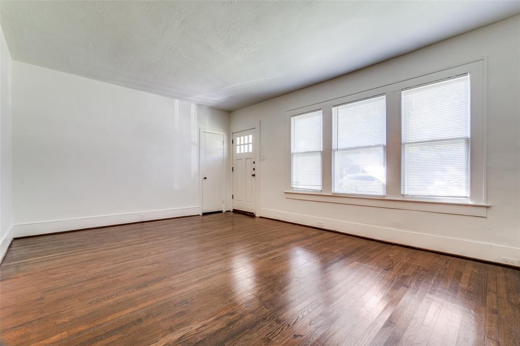 732 North Windomere Avenue Dallas, TX 75208 - Photo 5 of 33 an empty room with wooden floor and windows
