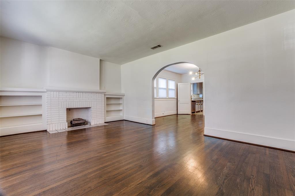 732 North Windomere Avenue Dallas, TX 75208 - Photo 6 of 33 a view of empty room with wooden floor and fireplace