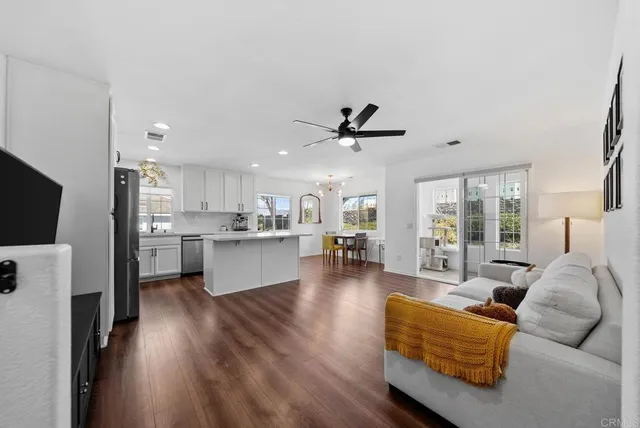 a living room with furniture and kitchen view