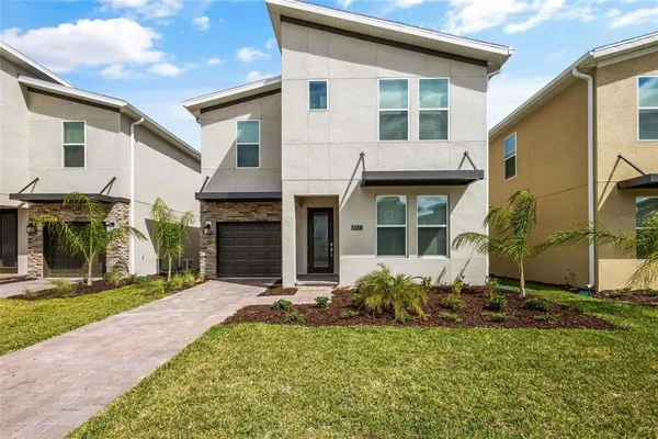 a front view of a house with a yard