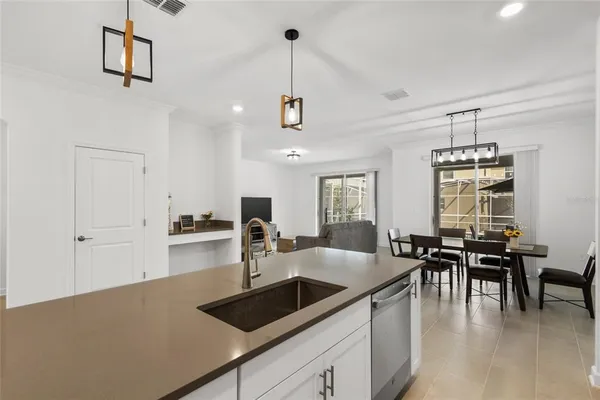 a kitchen with sink cabinets and dining table