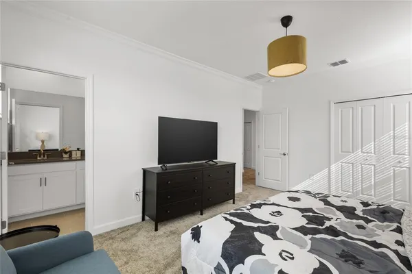 a bedroom with a bed and flat screen tv