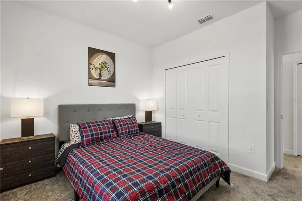 a bedroom with a bed and a night stand