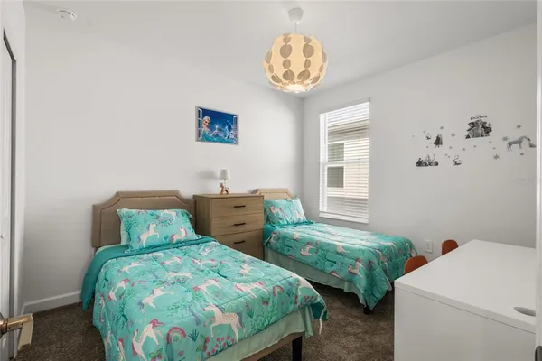 a bedroom with two beds and a table