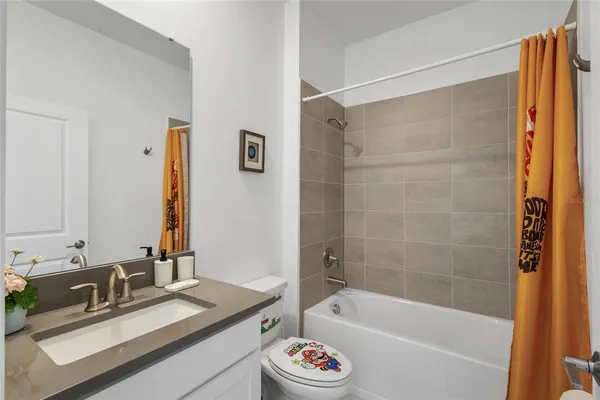 a bathroom with a tub sink and mirror