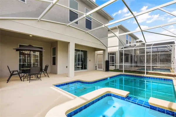 a room with pool table and glass door