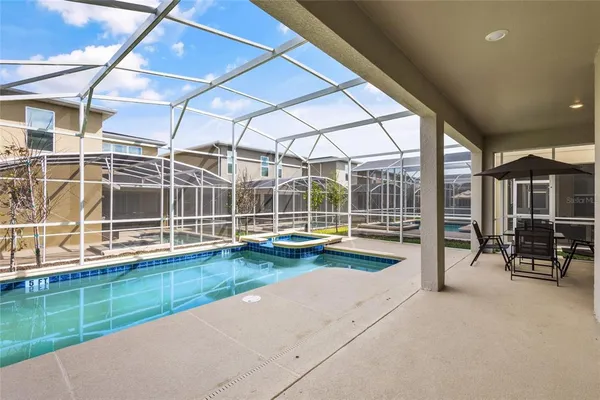 a view of swimming pool with outdoor seating