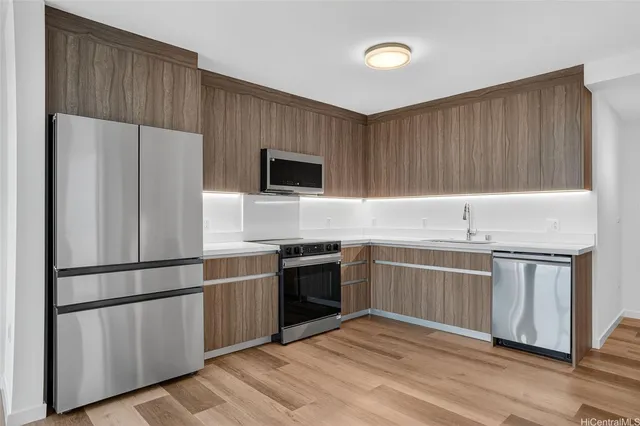 a kitchen with stainless steel appliances a refrigerator sink and microwave