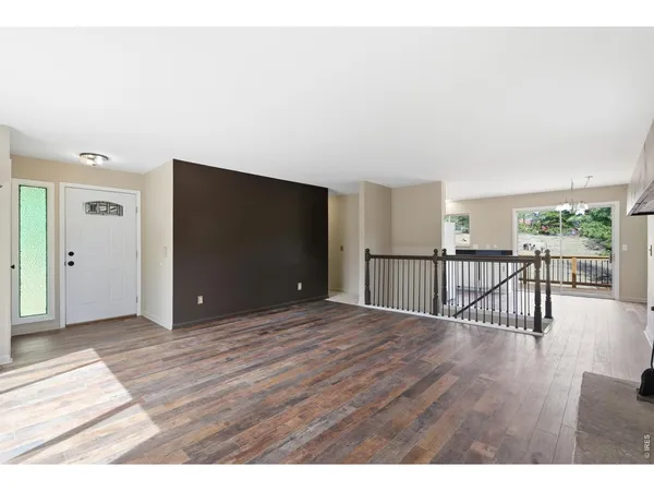 a view of a room with wooden floor