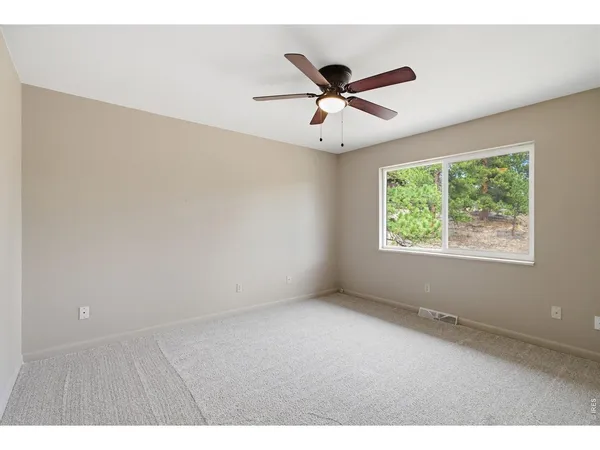 a view of a big room with wooden floor closet and windows