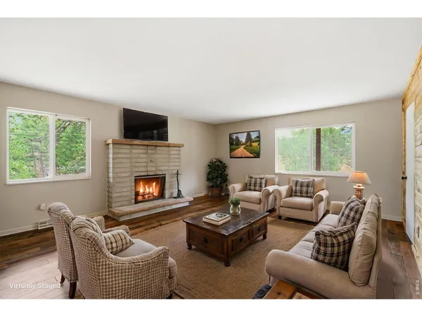 a living room with furniture fireplace and window